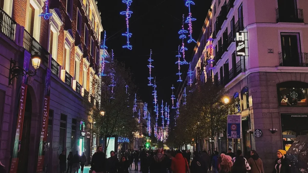 Personas caminando por la zona de Sol en Madrid de noche