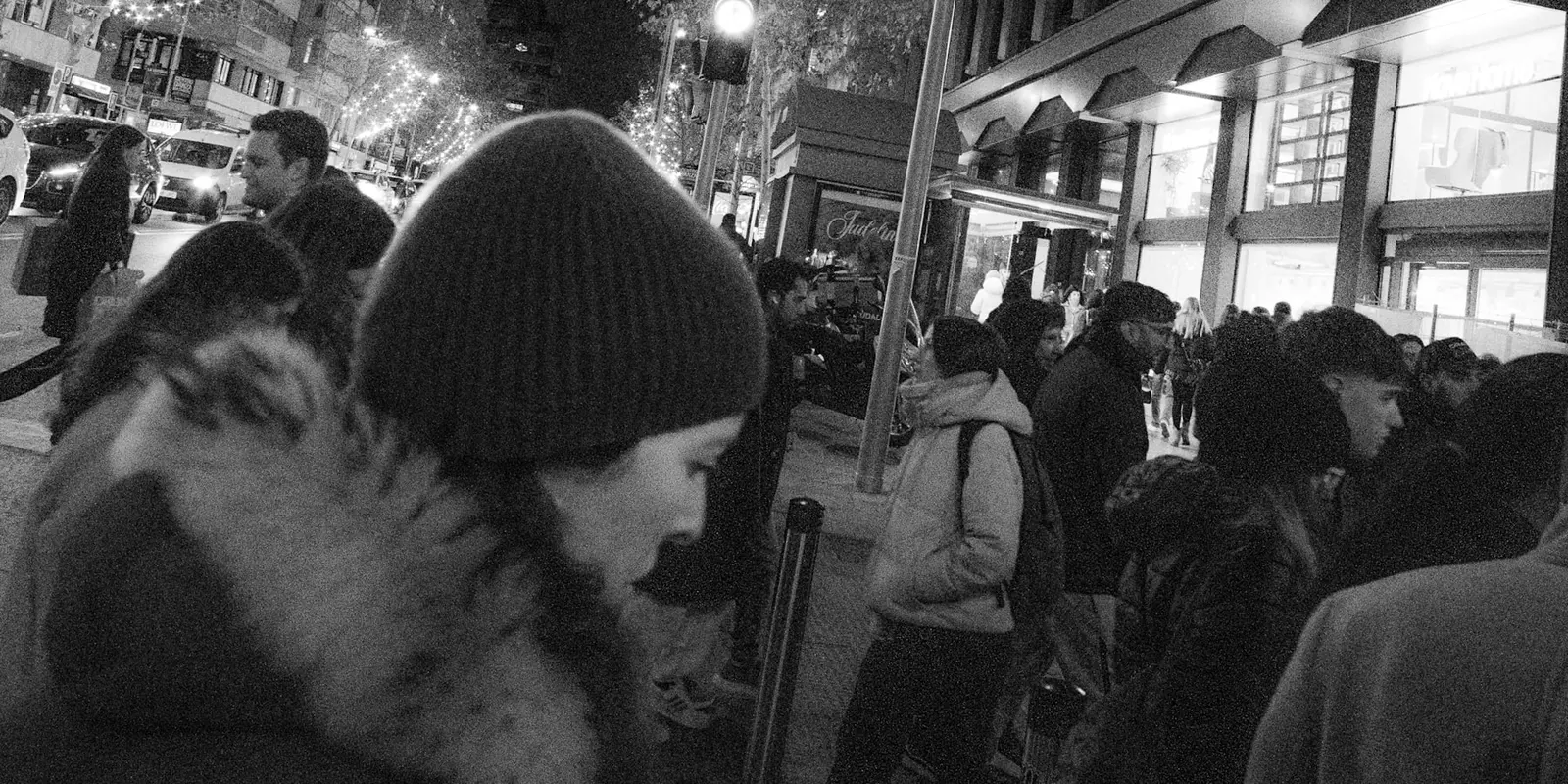 People walking along a Madrid street at night on a Sunday evening